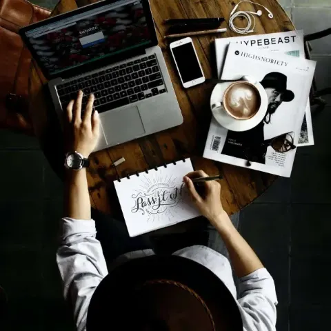 FAQ Section image Laptop, notebook and coffee on a work desk