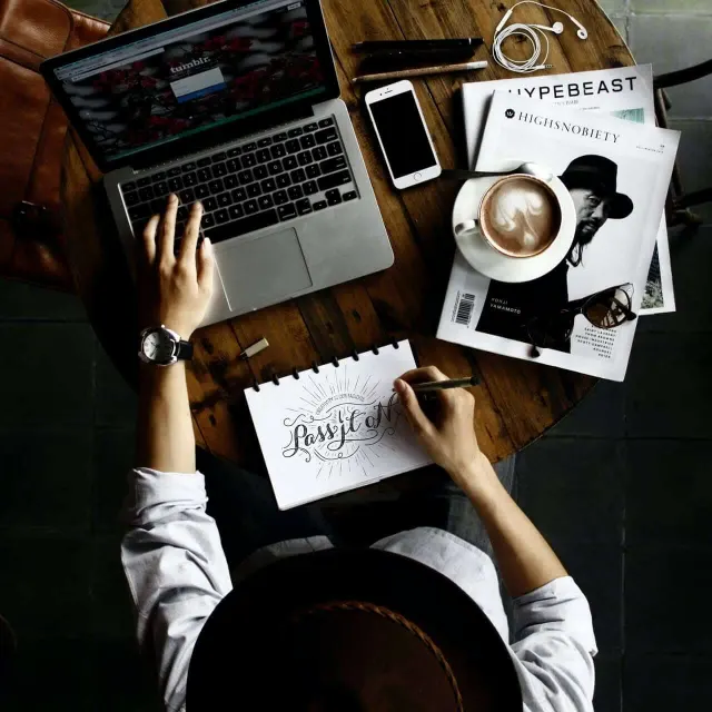 FAQ Section image Laptop, notebook and coffee on a work desk